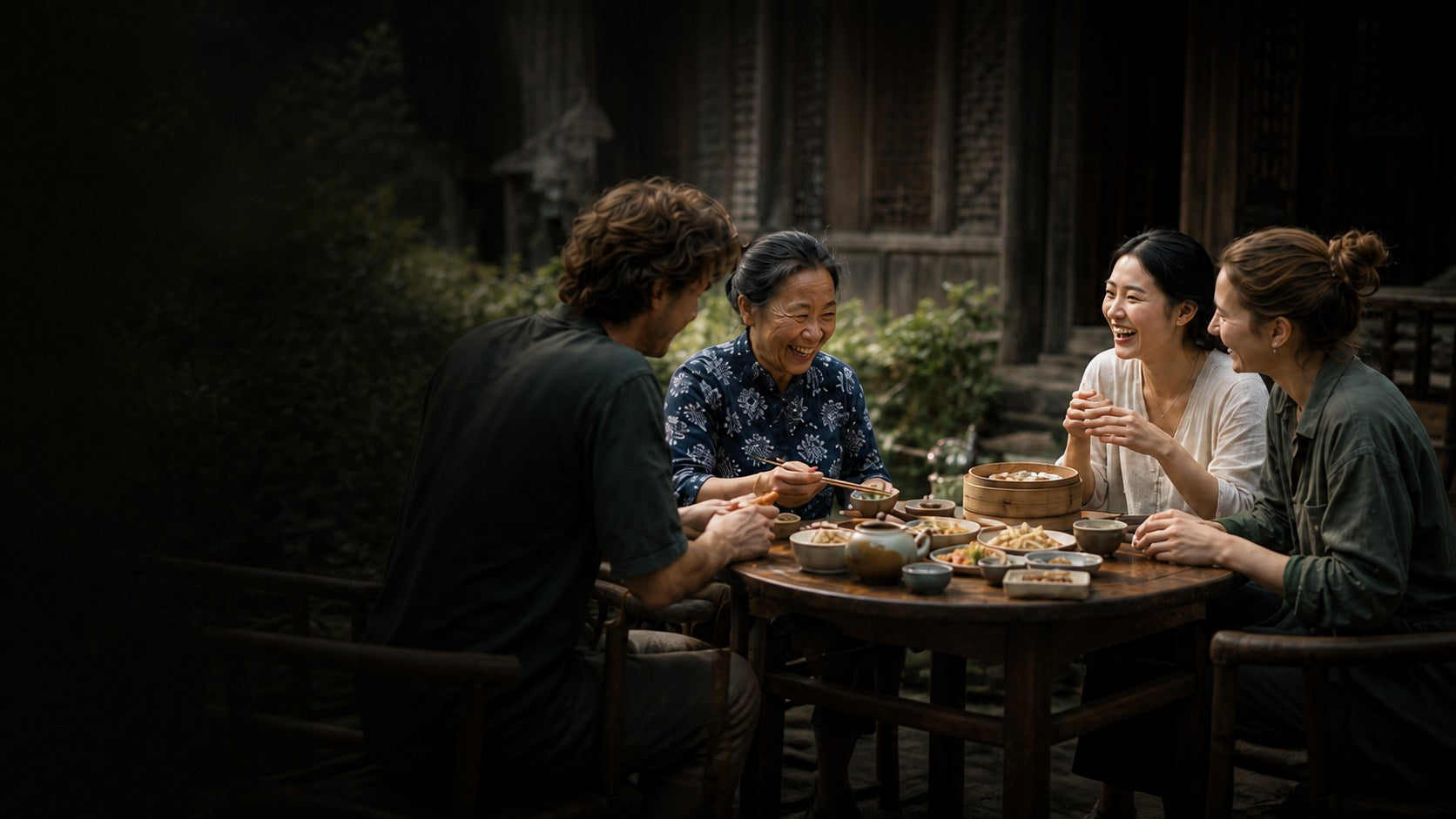 Travellers sharing a meal with a local host